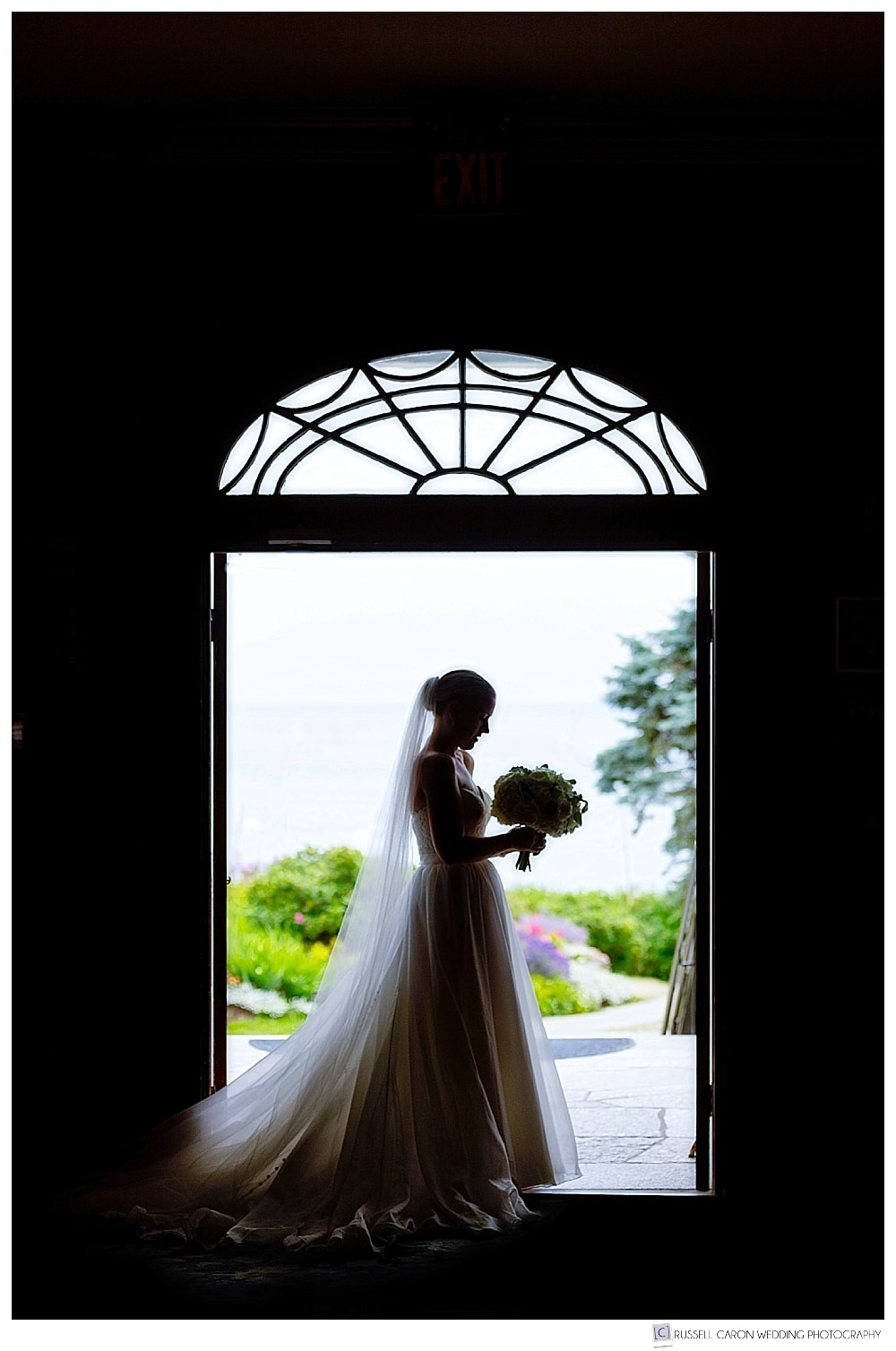 bride standing in the doorway of the colony hotel, kennebunkport, maine