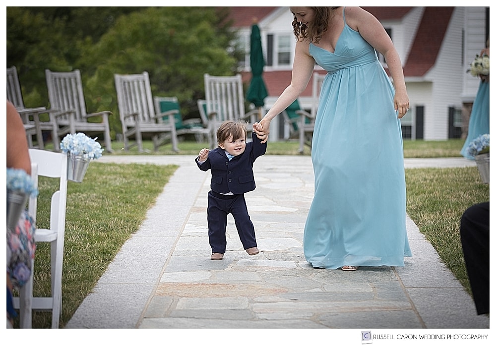 Bridesmaid and ring bearer walking down the aisle at the Colony Hotel, Kennebunkport, Maine