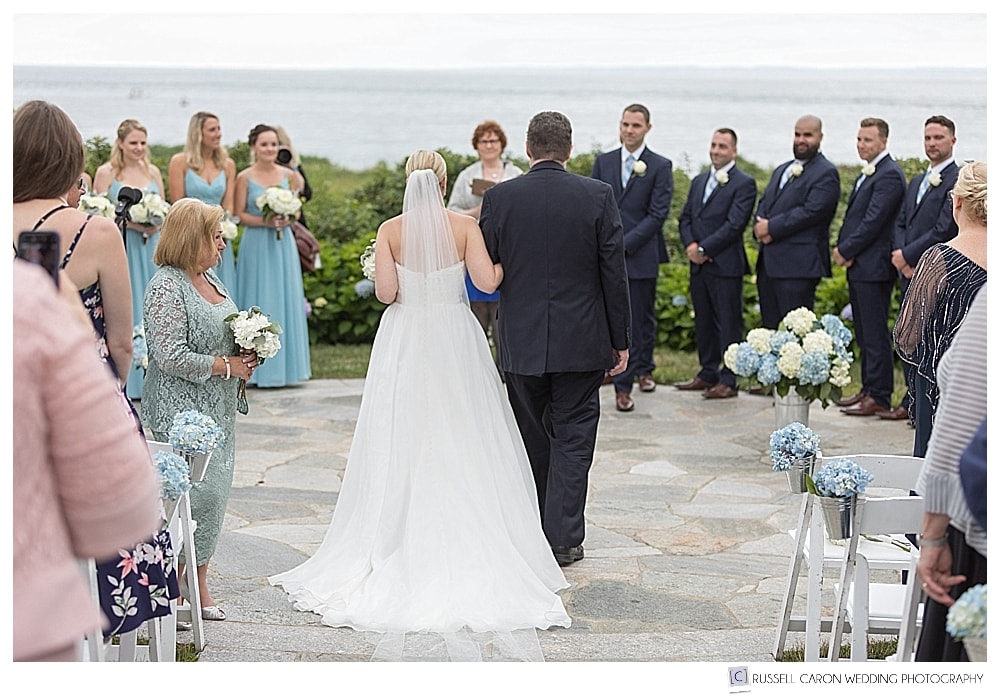 bride and her father reach the groom at a Colony Hotel Kennebunkport Maine wedding ceremony