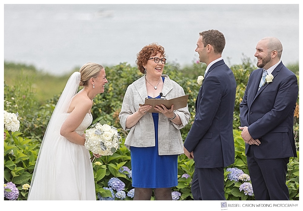 bride and groom laughing during their outdoor wedding ceremony at the Colony Hotel, Kennebunkport, Maine