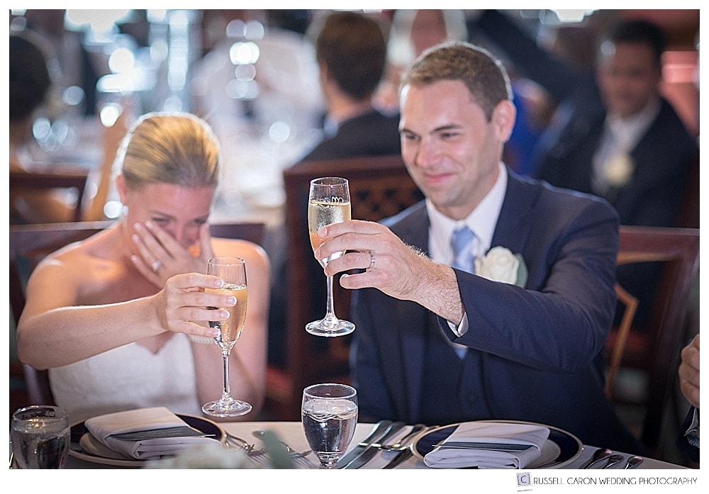 bride wipes her eyes during wedding toasts