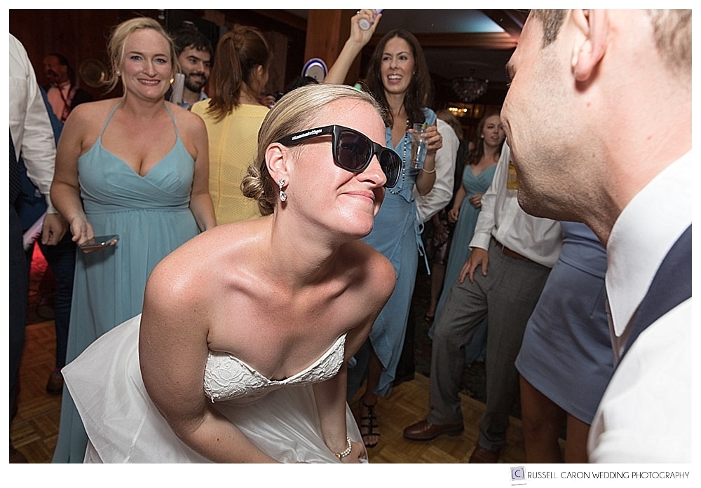 the bride wearing sunglasses as she dances at her Colony Hotel wedding reception
