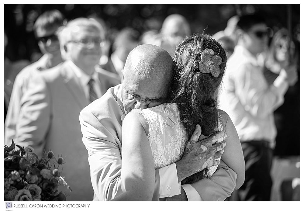 father hugging bride