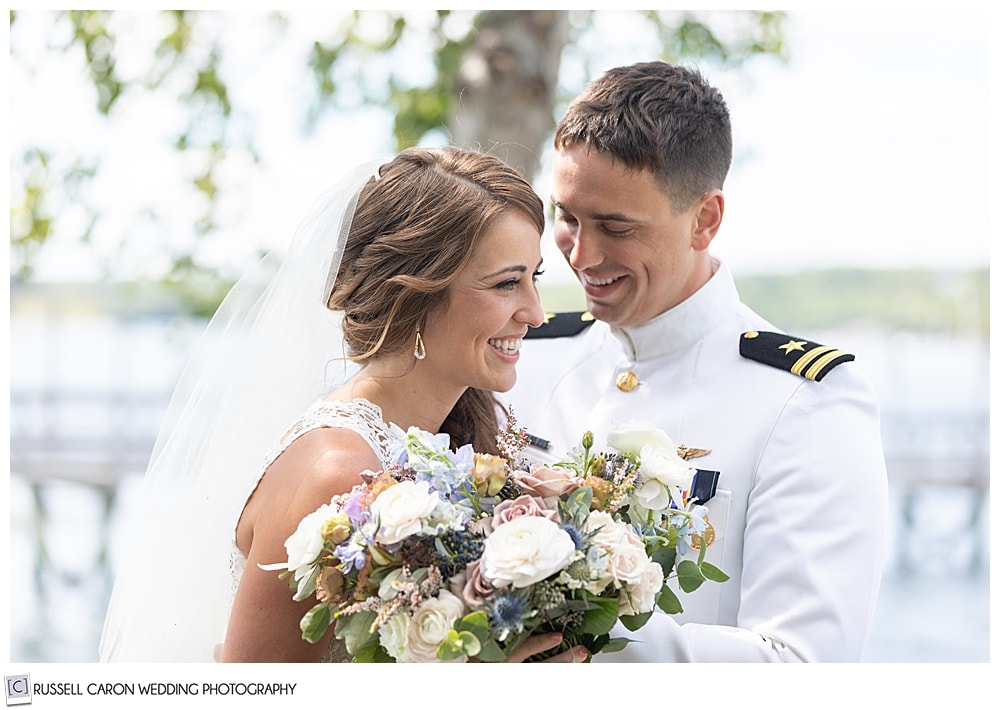 bride and groom smiling during their wedding day first look photos