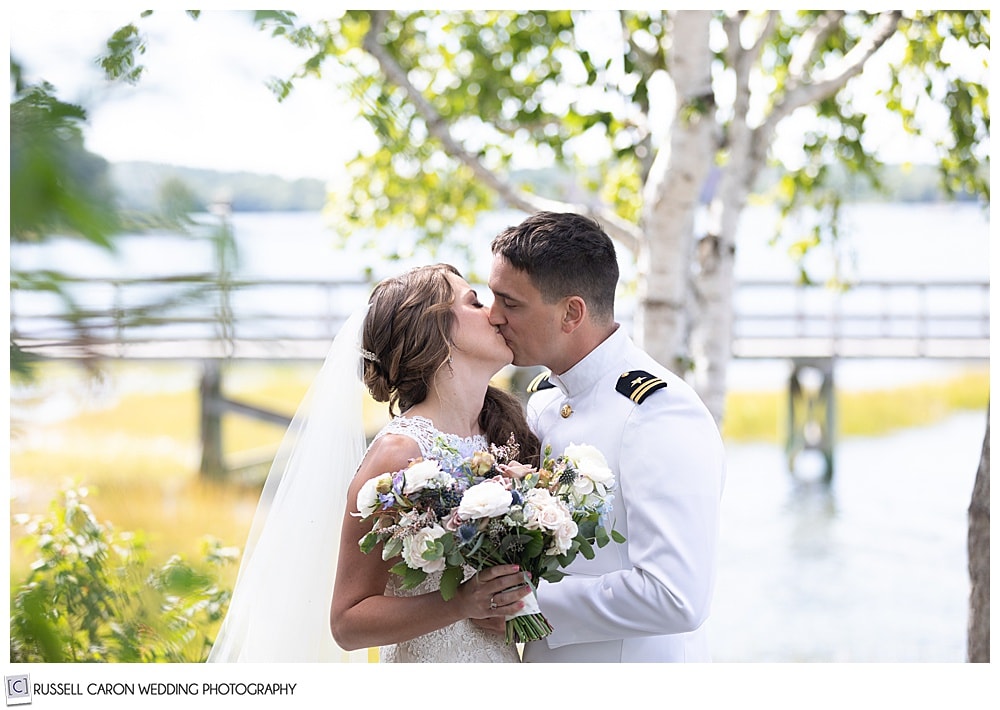 ride and groom kissing during their first look