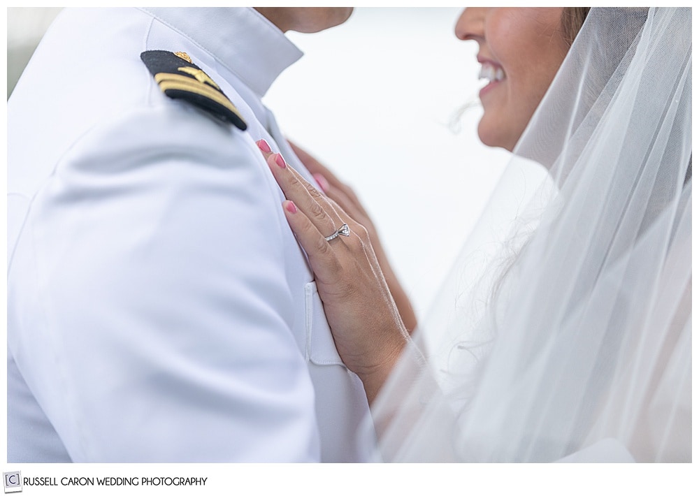 bride and groom standing face to face, bride's hands are on the groom's chest