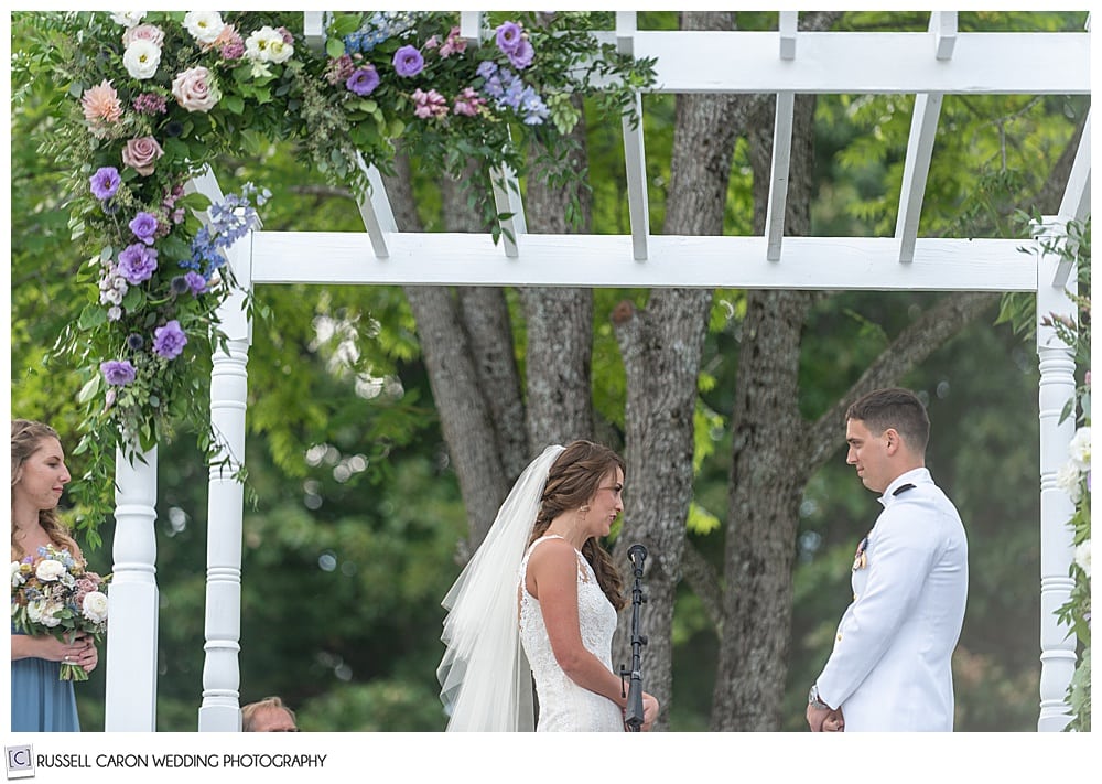 bride reciting her vows to her groom during their backyard Dresden Maine wedding ceremony