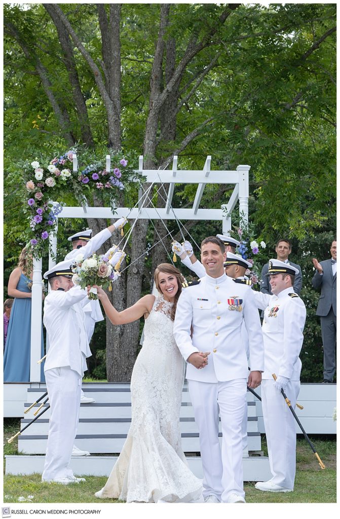 bride and groom during the recessional after going through a sword arch at their Dresden Maine wedding 