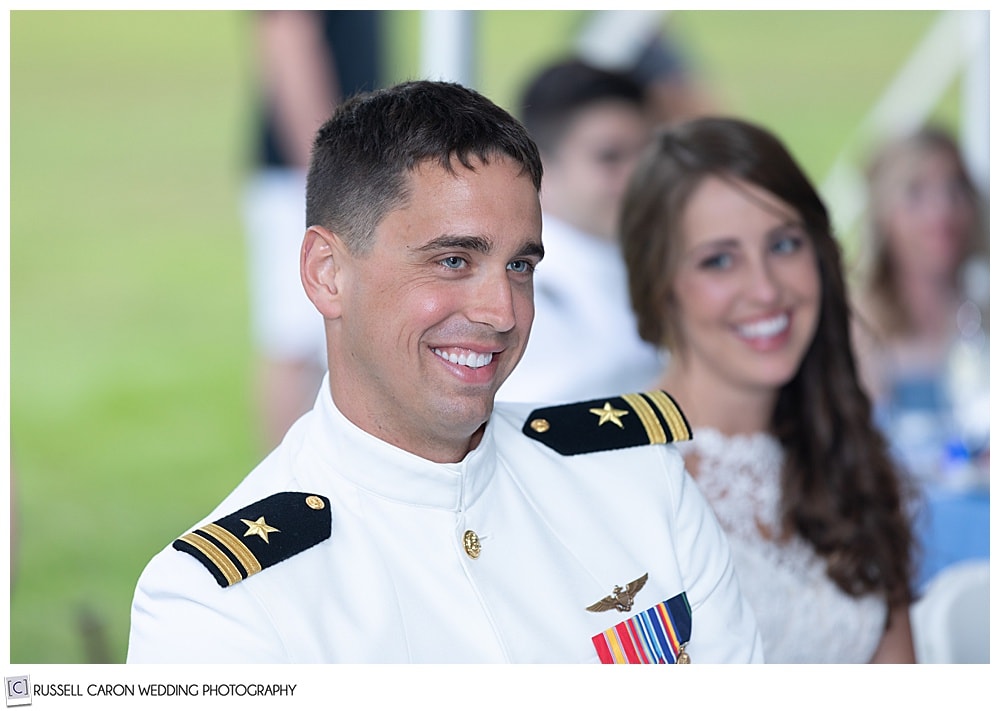 groom smiles during toasts