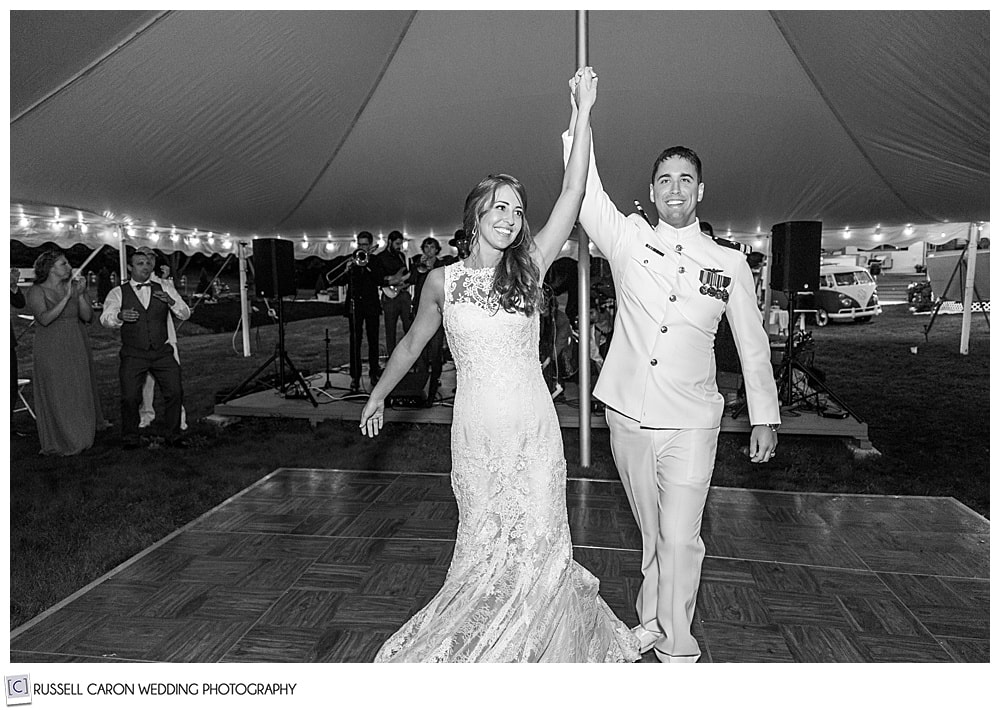 black and white photo of bride and groom being announced into their first dance