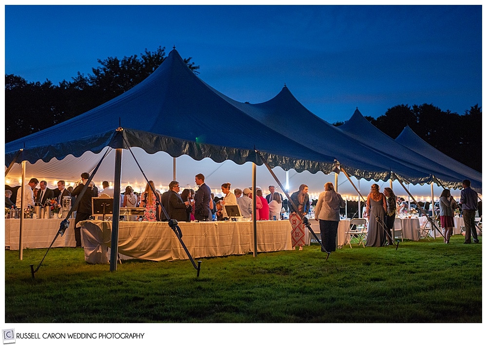 photo of a tented wedding during twilight in Maine