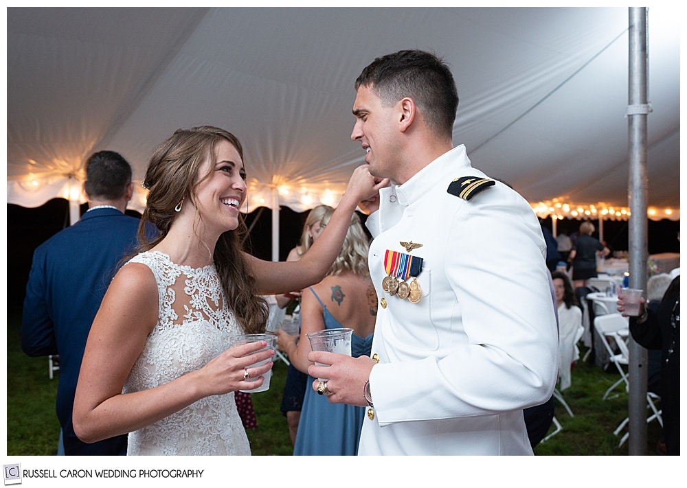 bride and groom standing together during their backyard Dresden Maine wedding reception