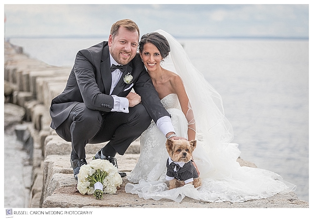 bride and groom pose with their dog