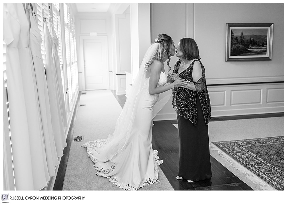 black and white photo of the bride and her mother kissing