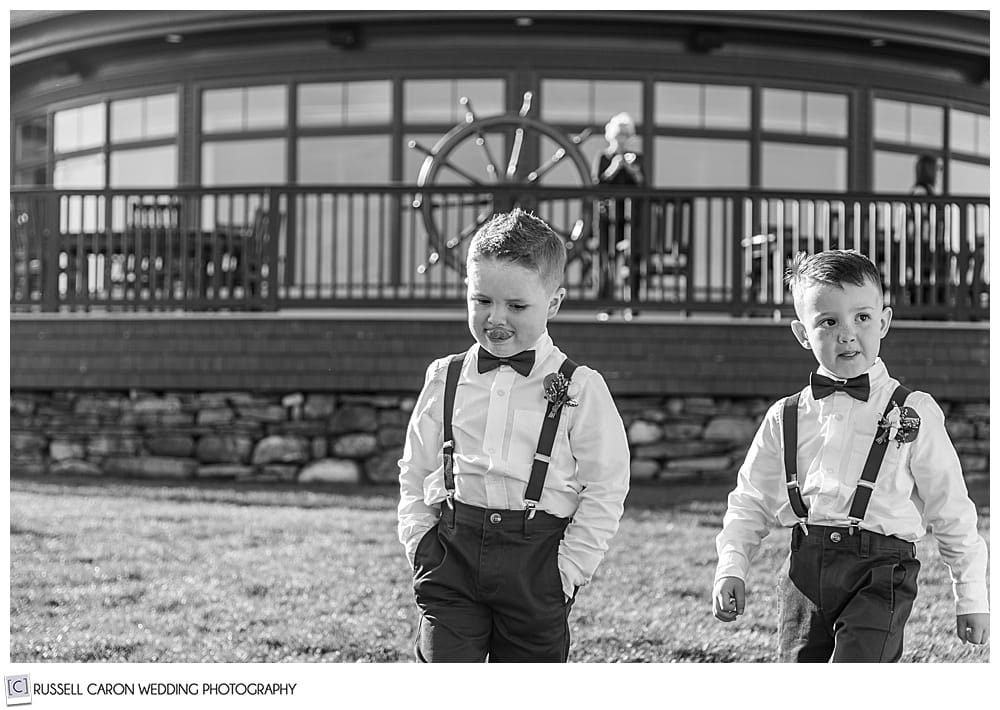 black and white photo of two ring bearers walking down the aisle during an elegant point lookout wedding