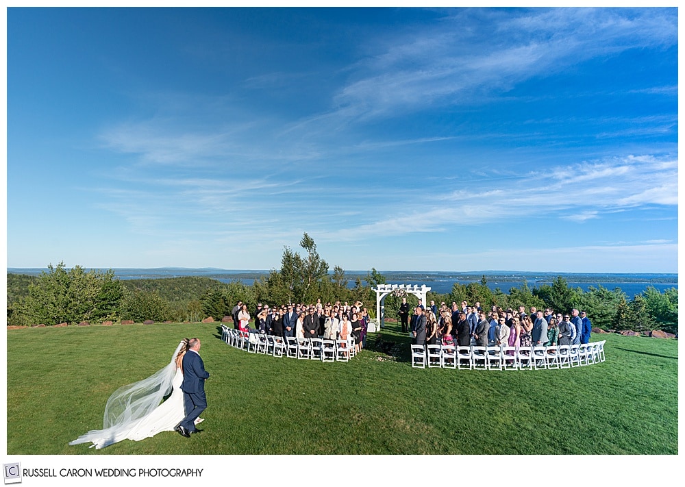 bride and her father approach the outdoor ceremony location at an elegant point lookout wedding