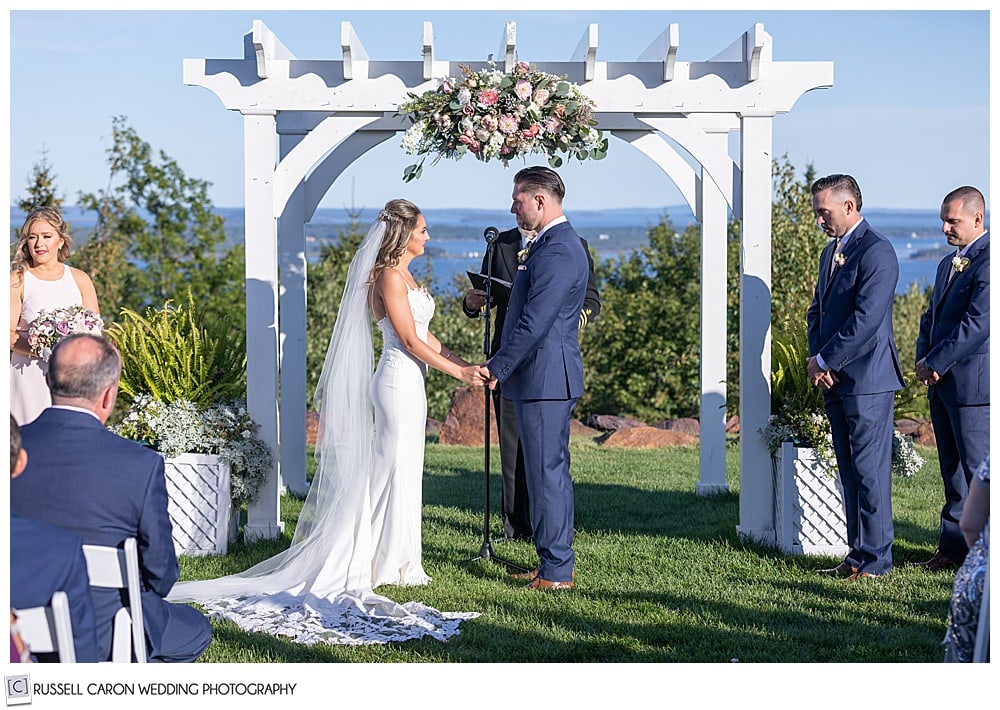 bride and groom stand together at their elegant point lookout wedding ceremony