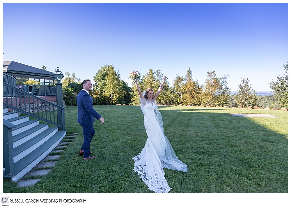 bride and groom after their wedding ceremony recessional, bride is raising her bouquet aloft