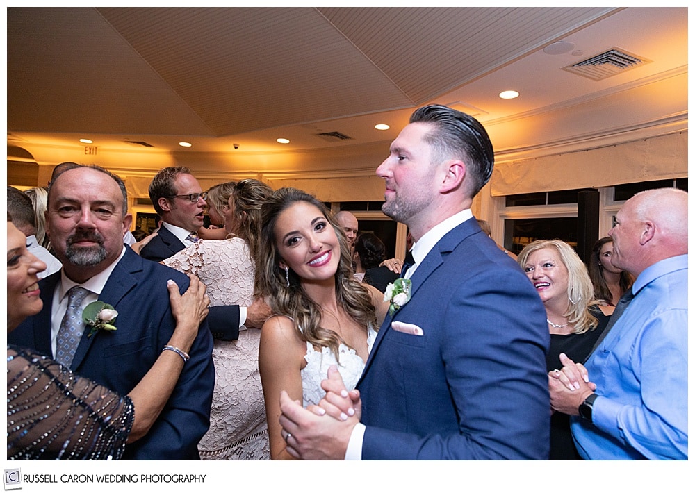 bride and groom dance with their guests at their elegant point lookout wedding reception