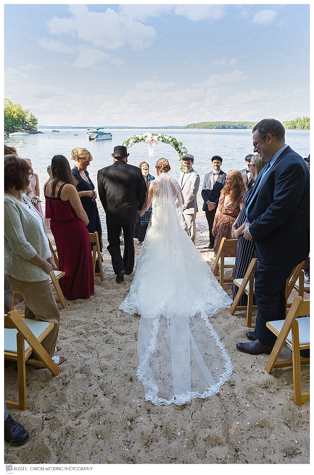 bride and her father arriving at the arbor during their Frye Island wedding