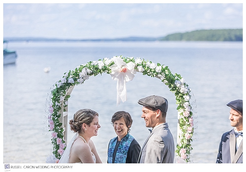 Bride, groom, and Rev Erika Hewitt officiating a Frye Island wedding