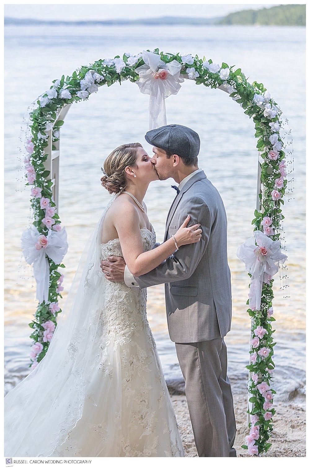 bride and groom's first kiss during Frye Island wedding
