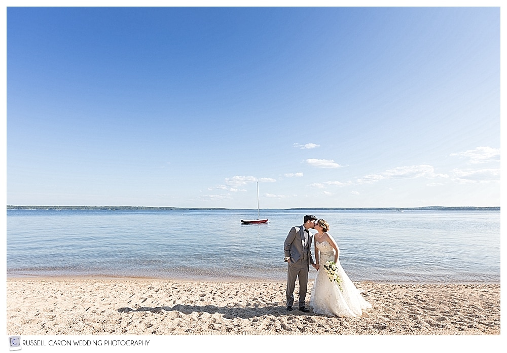 bride and groom kissing on Long Beach, Frye Island
