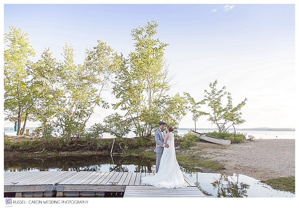 bride and groom standing on the dock at the Frye Island Marina, Frye Island