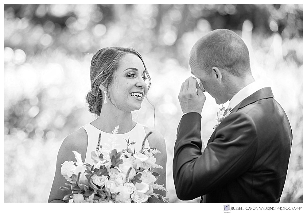 groom wipes away a tear during wedding day first look