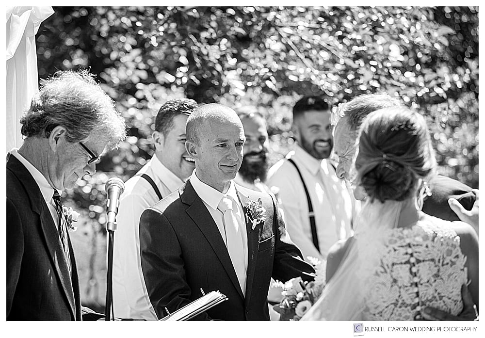 the groom greets the bride at an outdoor wedding ceremony at Gilsland Farm Audubon Center in Falmouth, Maine