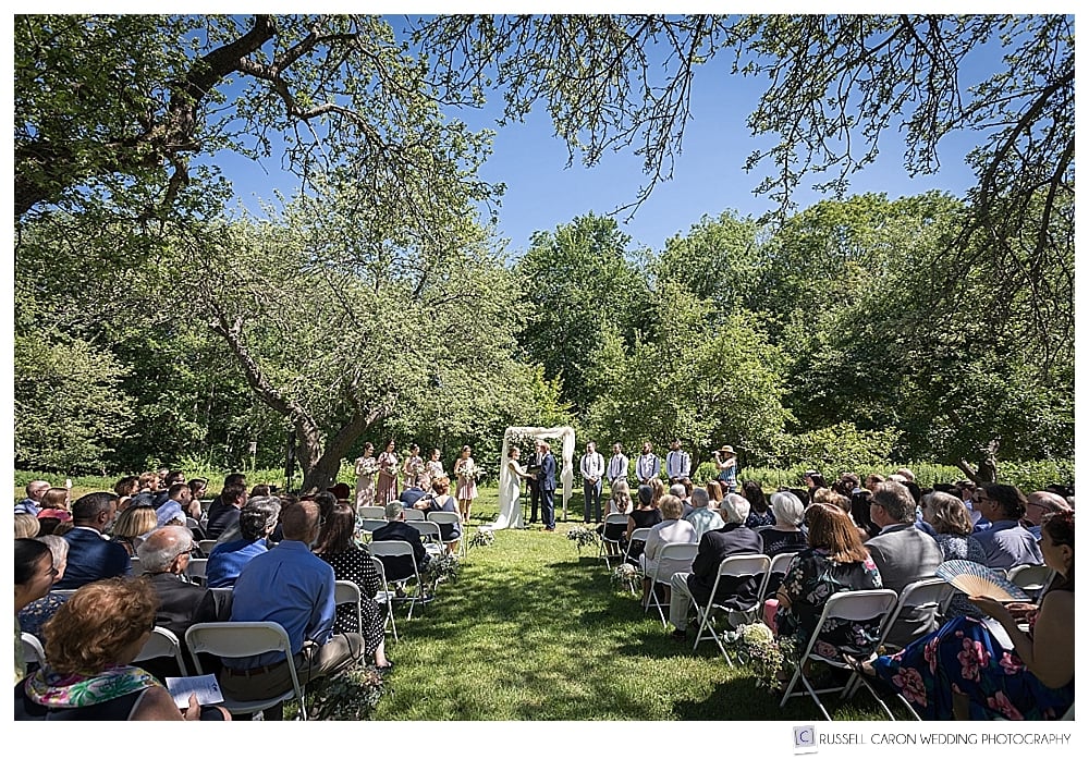 outdoor wedding ceremony in the apple orchard at Gilsland Farm Audubon Center, Falmouth, Maine