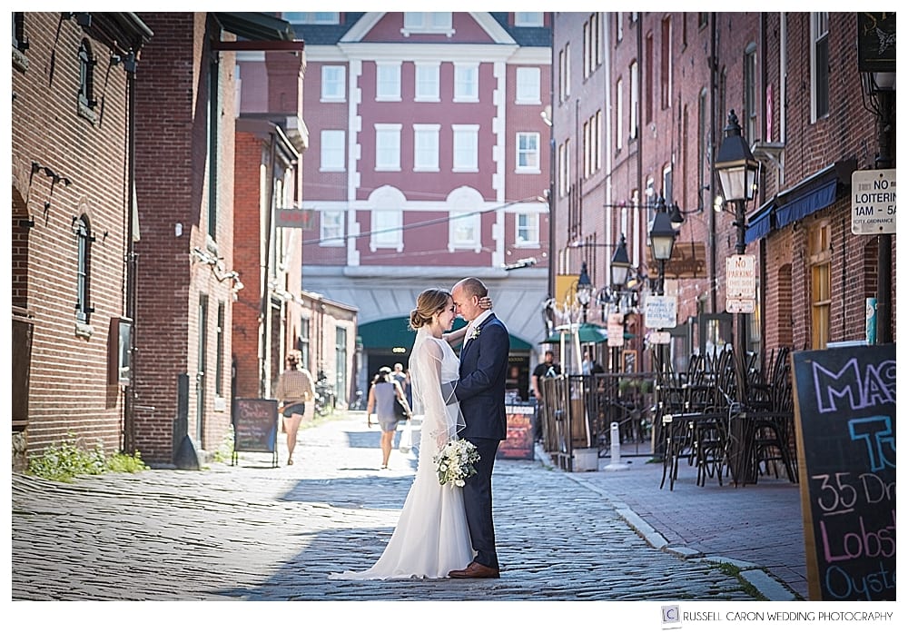 bride and groom on the cobbled streets of Portland Maine. Wharf Street Portland Maine wedding photography, Maine wedding photographers