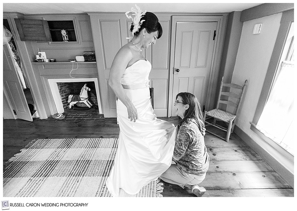 black and white photo of bride and matron of honor laughing