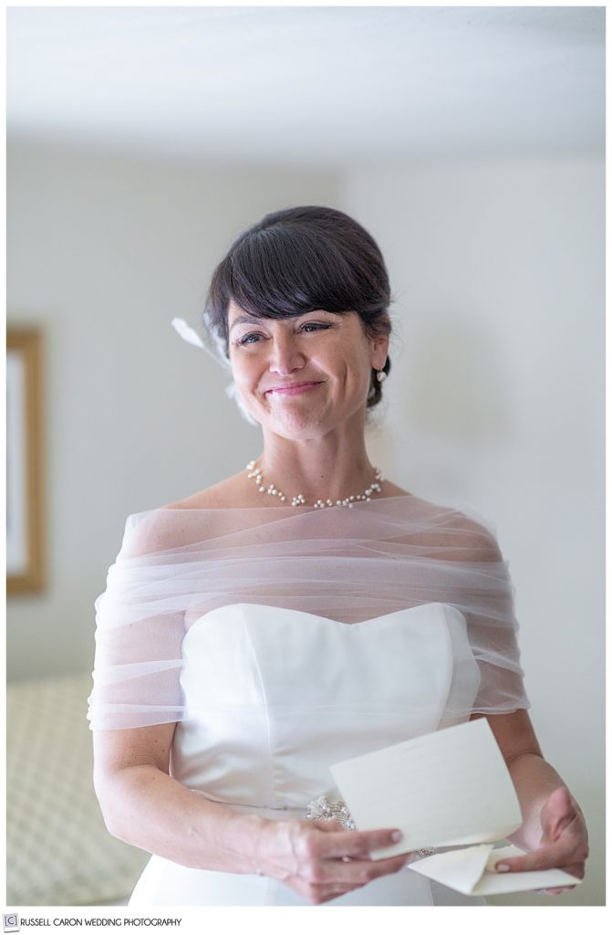 bride smiling with letter in hand