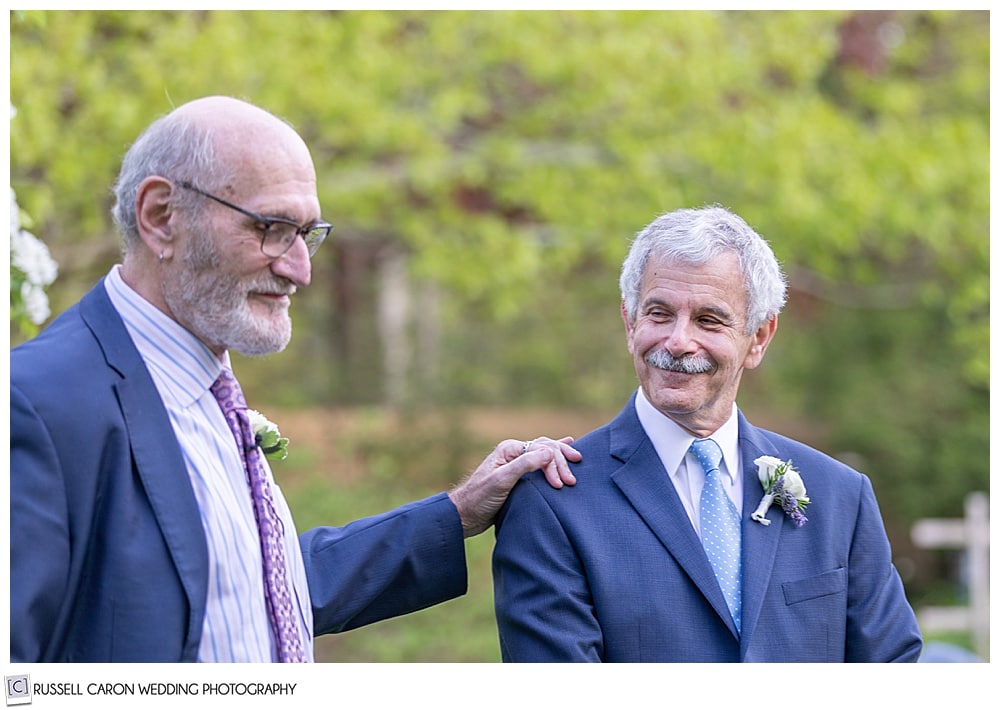 photo of the groom with his friend's hand on his shoulder