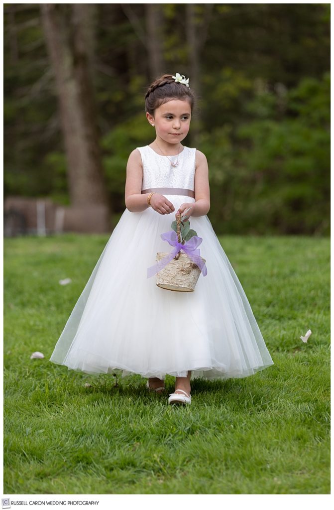 flower girl dropping flower petals on the grass