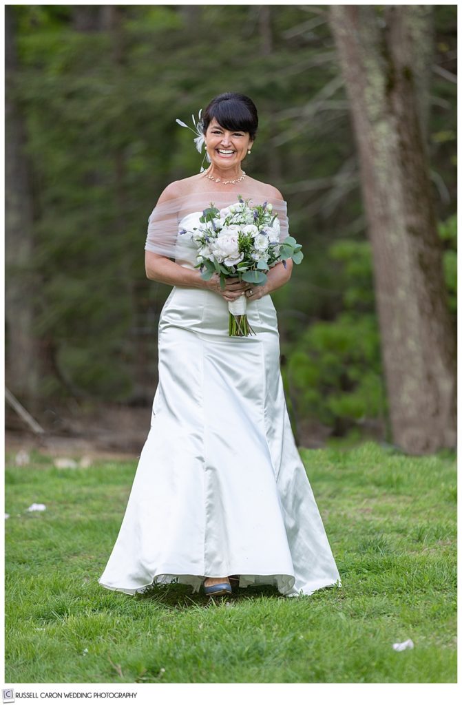 smiling bride walking down the aisle