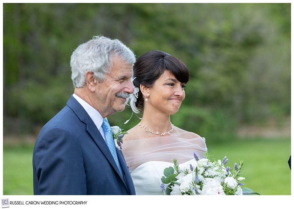 bride and groom standing next to one another during their outdoor wedding ceremony