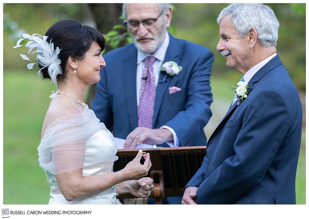 bride holding the groom's wedding band