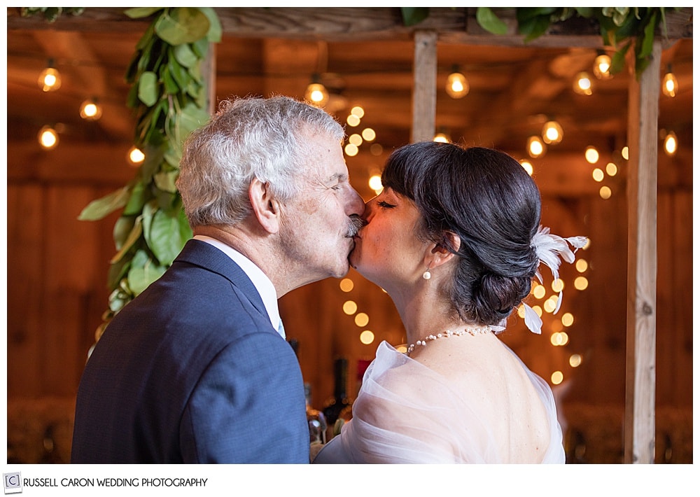 bride and groom kissing each other surrounded by lbokeh