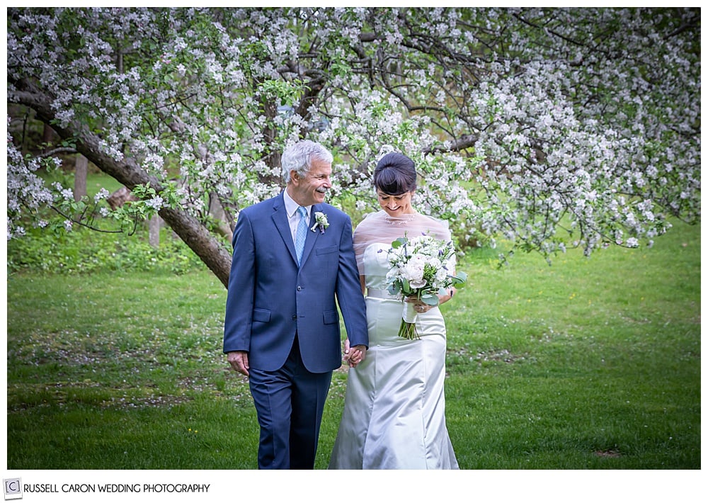 bride and groom walking together holding hands