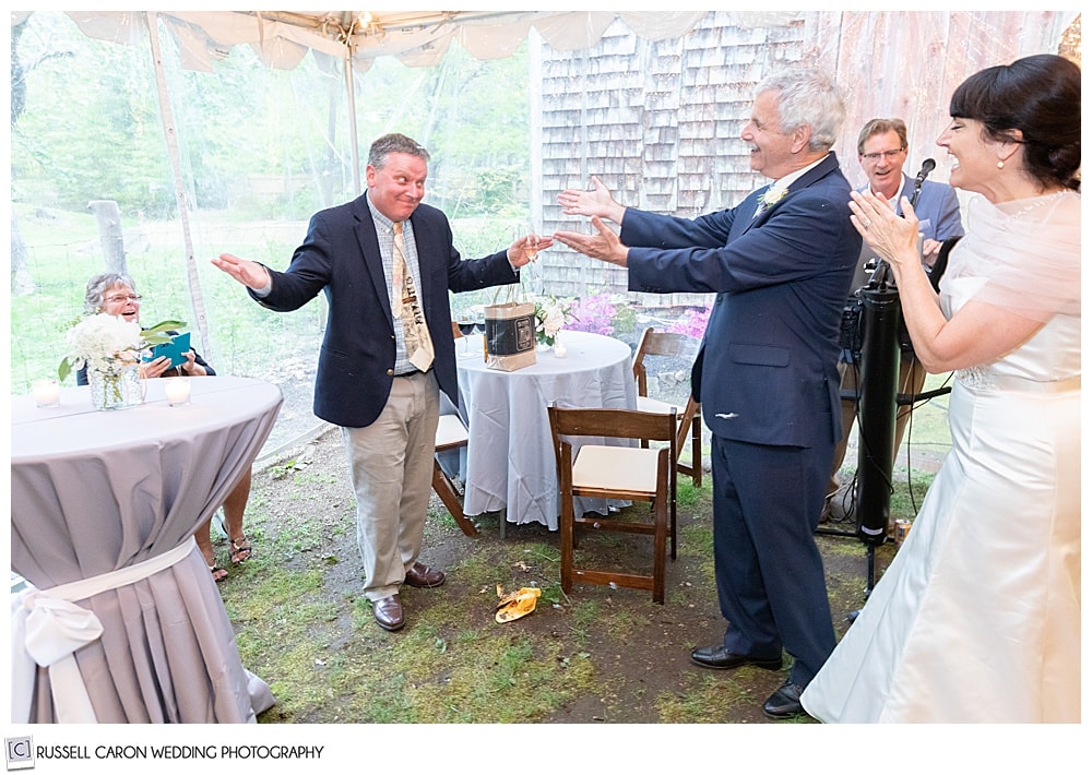 bride and groom laughing with friend