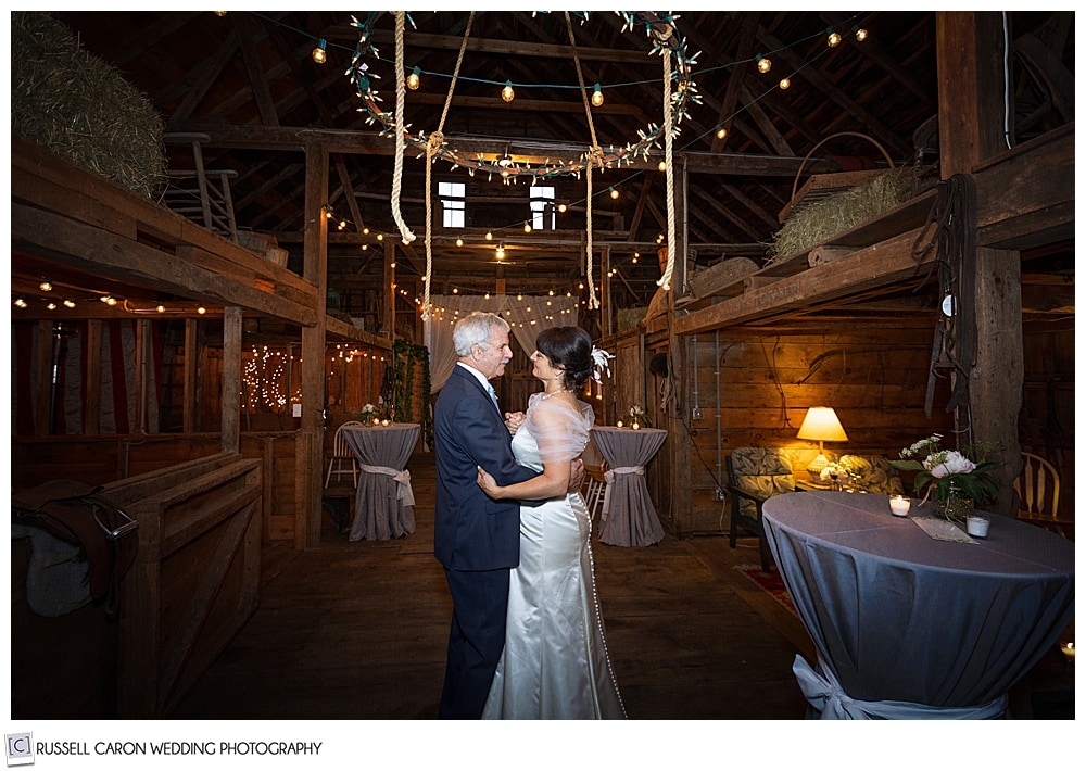 ride and groom dancing in a barn