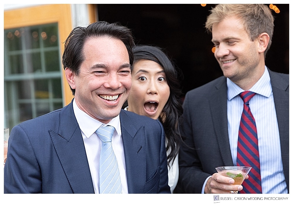 bride making funny face with wedding guests
