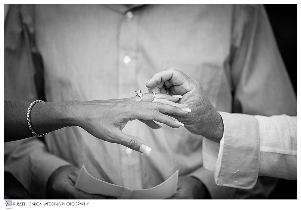 groom-puts-wedding-ring-on-bride's-finger