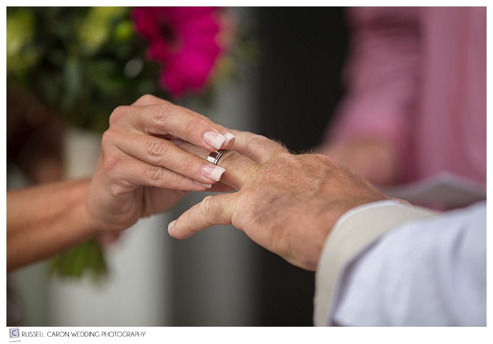 bride-puts-wedding-ring-on-groom's-finger