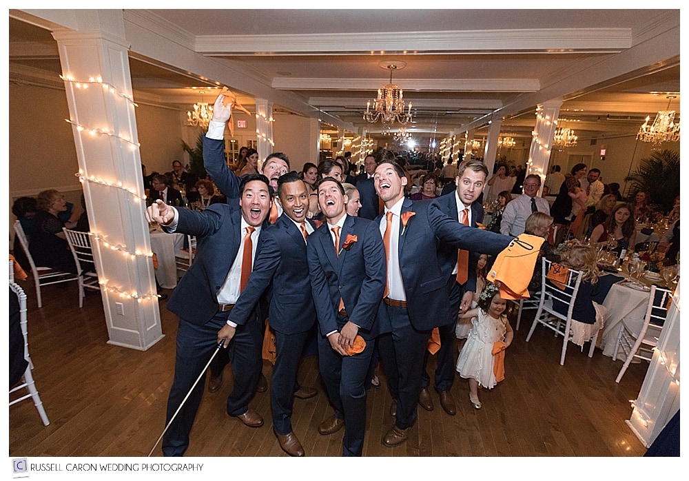 groomsmen taking a selfie during wedding reception