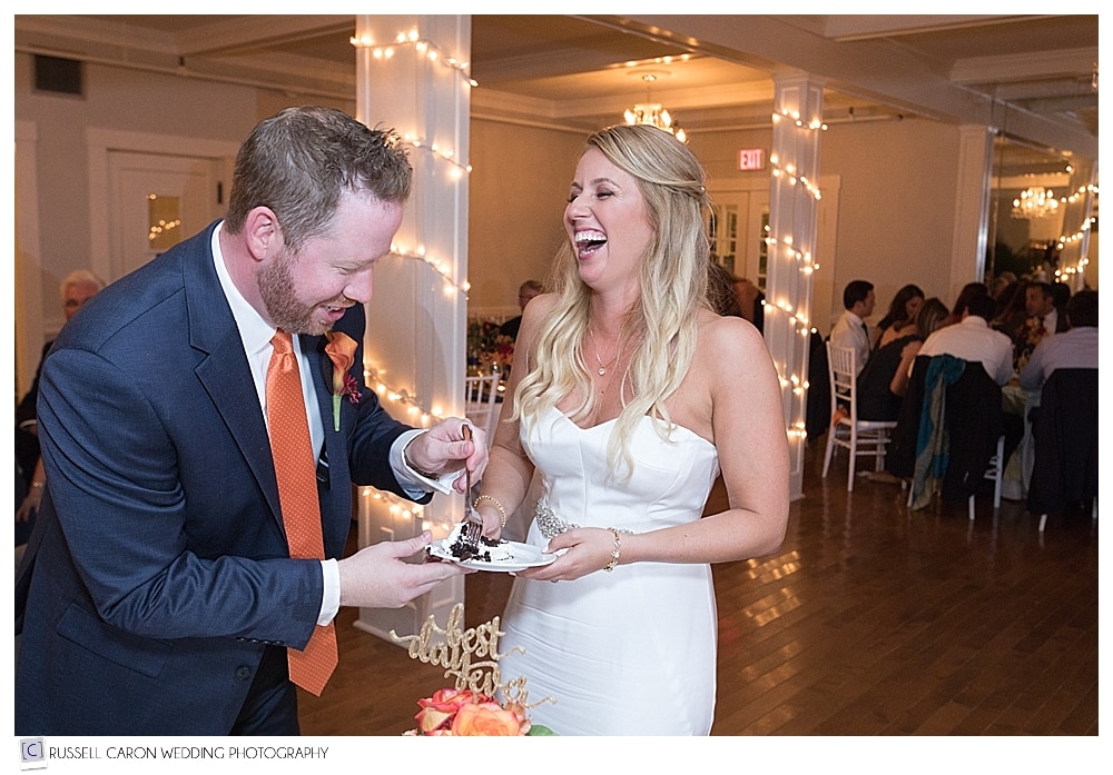 bride and groom laughing during cake cutting