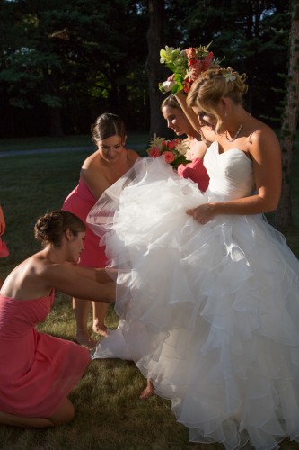 Bridesmaids helping bride