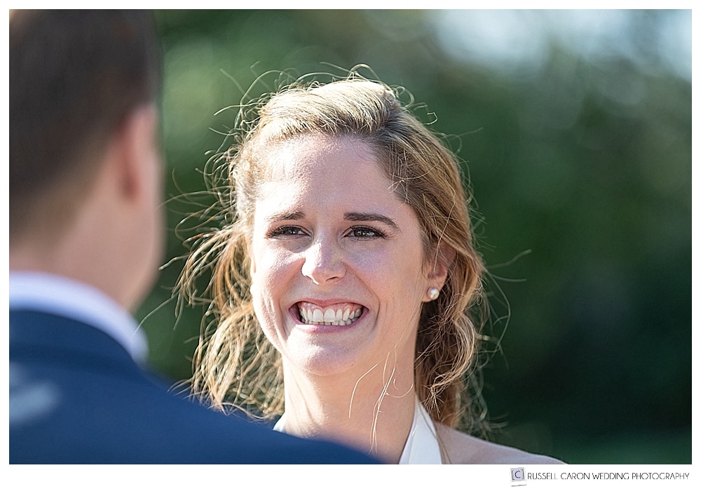 bride smiling at groom during wedding ceremony